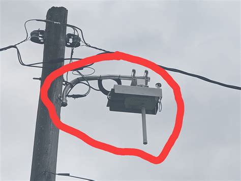 big round metal box on powerline|strange boxes on utility poles.